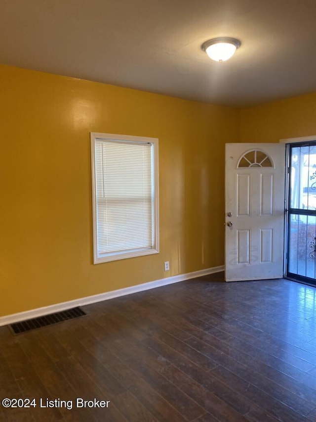 empty room featuring dark hardwood / wood-style flooring