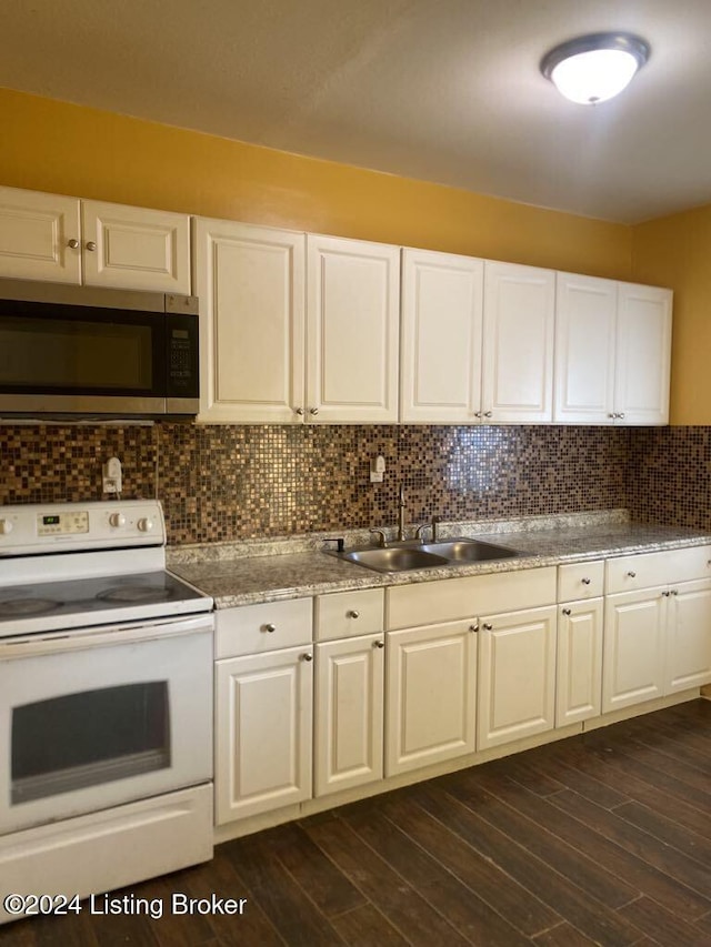 kitchen featuring sink, dark wood-type flooring, white range with electric cooktop, decorative backsplash, and white cabinets