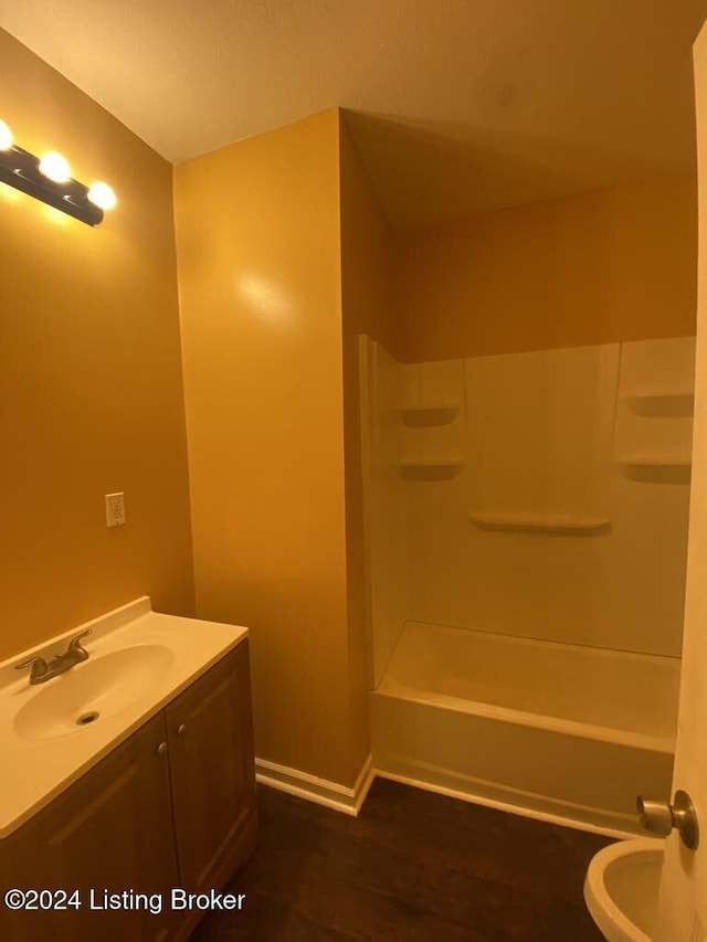 full bathroom with hardwood / wood-style flooring, vanity, toilet, and shower / tub combination