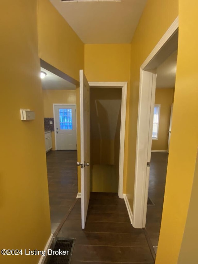 corridor with dark hardwood / wood-style floors