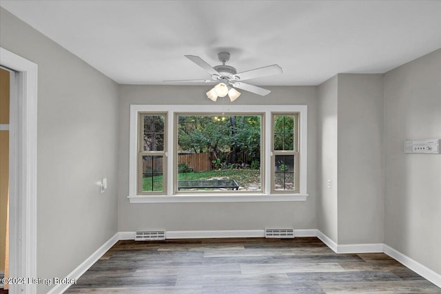 empty room with hardwood / wood-style flooring and ceiling fan