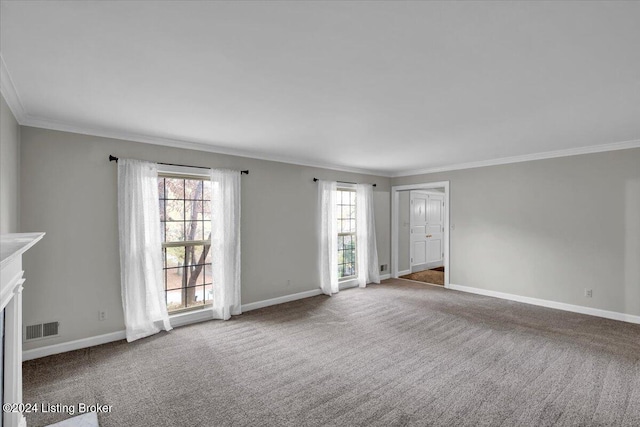 unfurnished living room with ornamental molding, carpet, and a healthy amount of sunlight