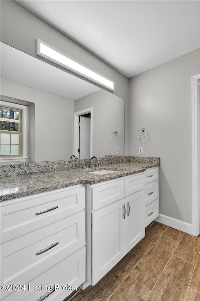 bathroom with hardwood / wood-style floors and vanity