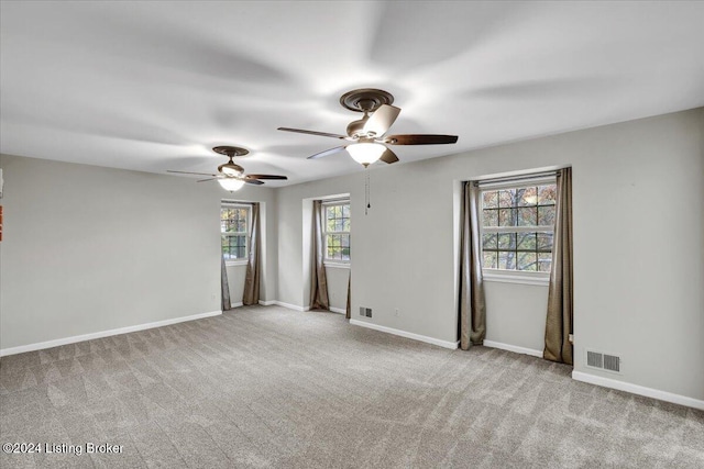 unfurnished room featuring ceiling fan and light colored carpet