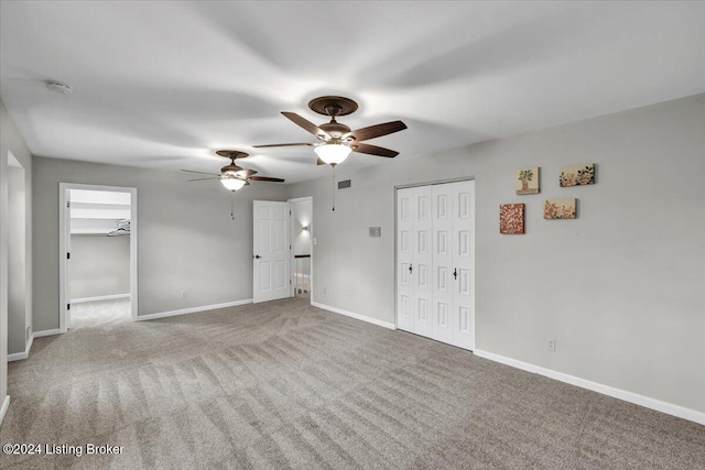 unfurnished bedroom featuring carpet and ceiling fan