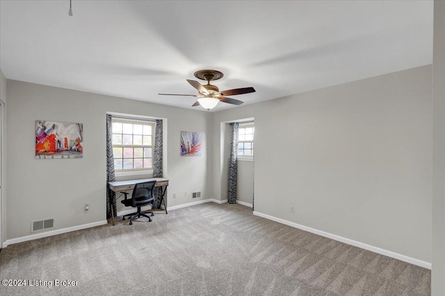 unfurnished office with light carpet and ceiling fan