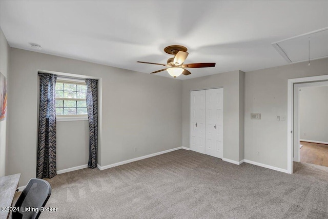 unfurnished bedroom with ceiling fan, a closet, and carpet floors