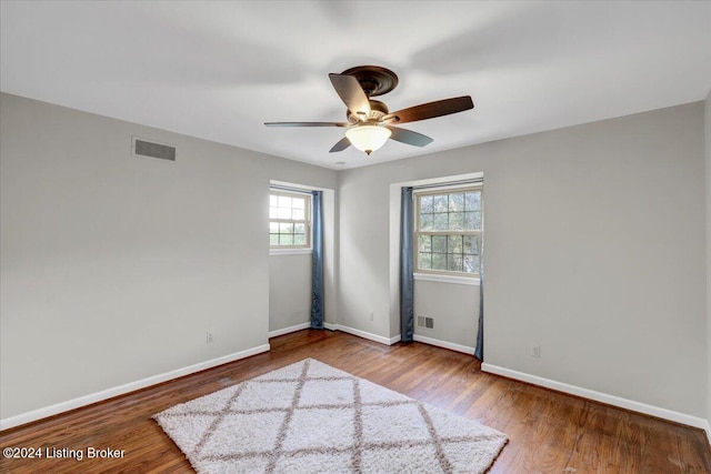 unfurnished room with hardwood / wood-style flooring and ceiling fan