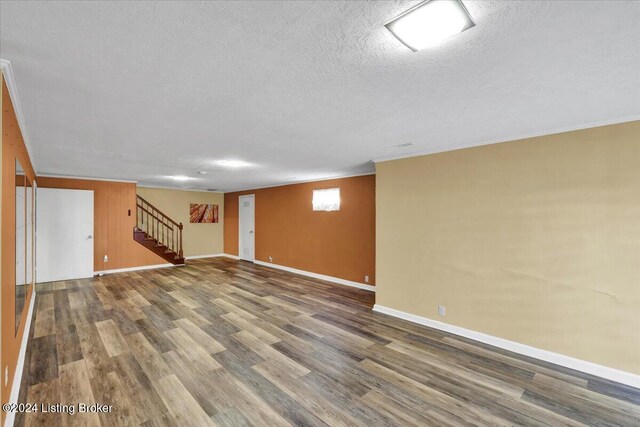 basement featuring hardwood / wood-style flooring and a textured ceiling