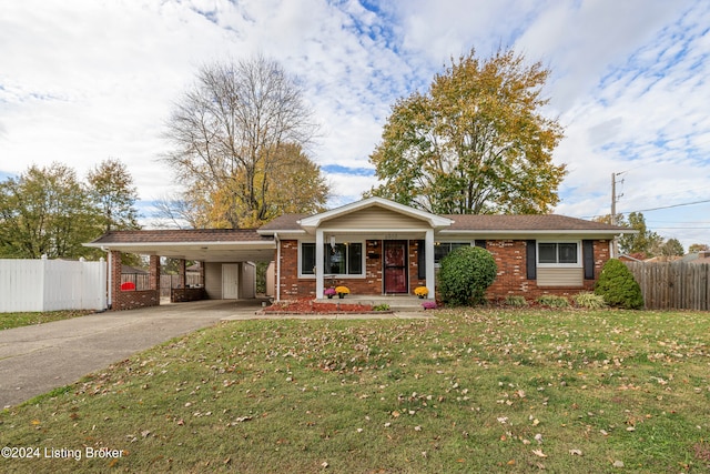 ranch-style house featuring a front lawn and a carport