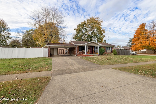 single story home with a front lawn and a carport