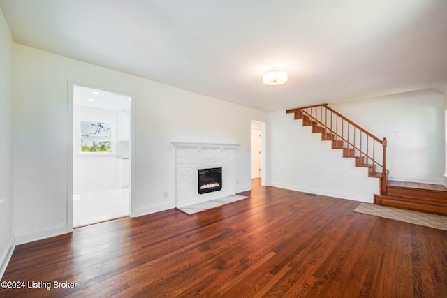 unfurnished living room with a fireplace and dark hardwood / wood-style floors