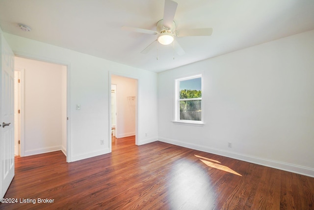 unfurnished bedroom with dark hardwood / wood-style flooring, a closet, and ceiling fan