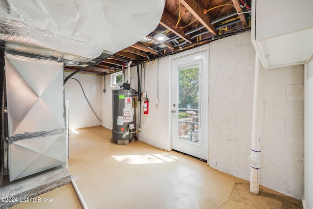 basement with water heater and heating unit