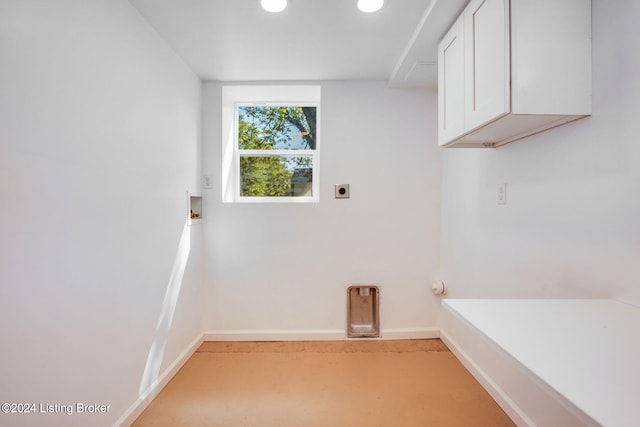 clothes washing area featuring cabinets, washer hookup, and hookup for an electric dryer