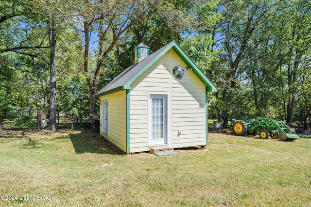 view of outbuilding with a lawn