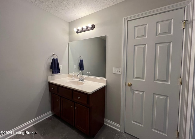 bathroom featuring vanity and a textured ceiling