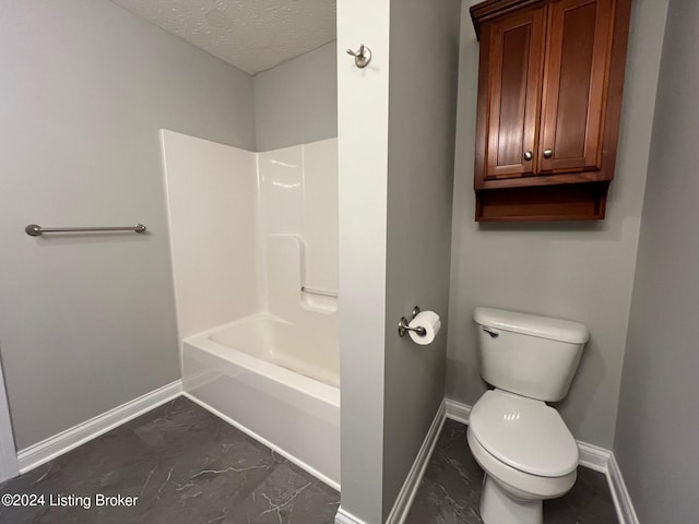 bathroom featuring a textured ceiling, toilet, and shower / bathing tub combination