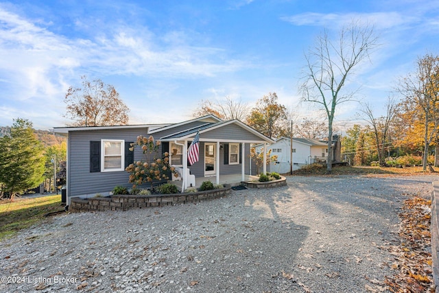 22 Harmony Ln, Clarkson, KY 42726 - bungalow-style home with a porch and gravel driveway