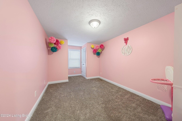 interior space featuring carpet flooring and a textured ceiling