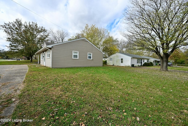 view of side of home with a lawn