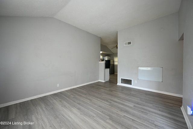 unfurnished living room featuring hardwood / wood-style floors, lofted ceiling, and ceiling fan