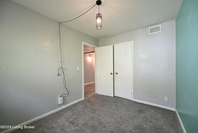 unfurnished bedroom featuring dark carpet