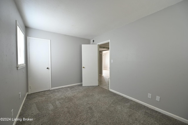 unfurnished bedroom with carpet flooring