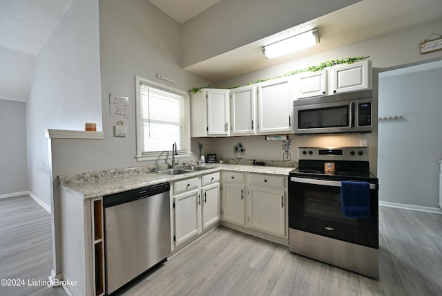 kitchen with light wood-type flooring, white cabinets, sink, and stainless steel appliances