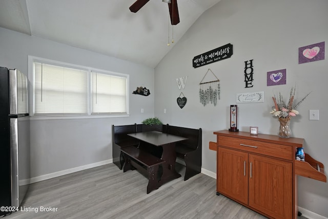 dining room featuring light hardwood / wood-style flooring, ceiling fan, and vaulted ceiling