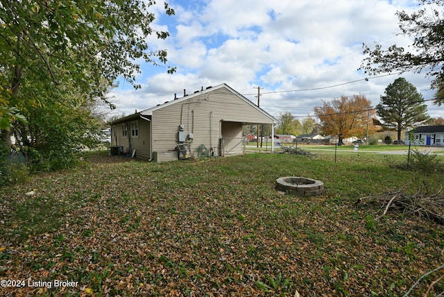 exterior space featuring a lawn and a fire pit