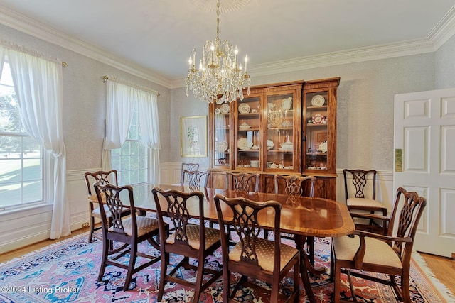 dining room featuring an inviting chandelier, wood-type flooring, and crown molding