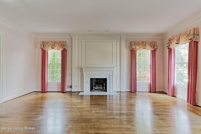 unfurnished living room featuring a premium fireplace, light hardwood / wood-style flooring, and crown molding