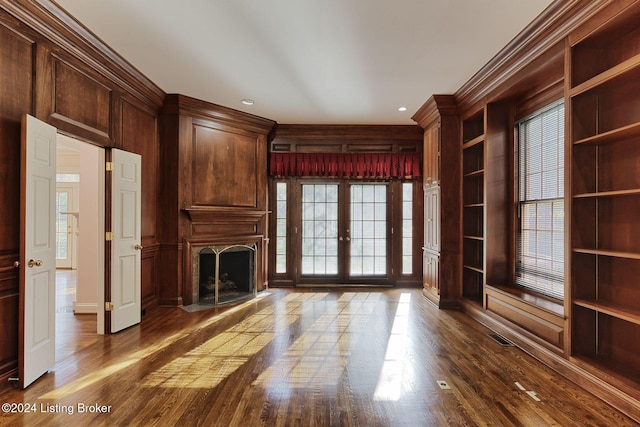 unfurnished living room with ornamental molding, french doors, and hardwood / wood-style flooring