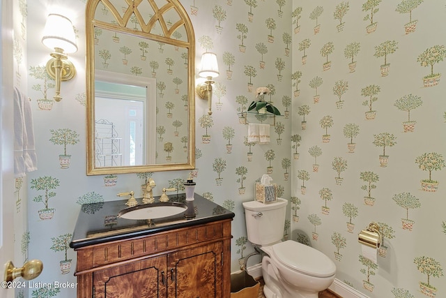 bathroom featuring toilet and vanity