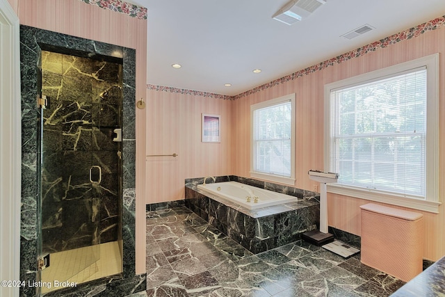 bathroom featuring independent shower and bath