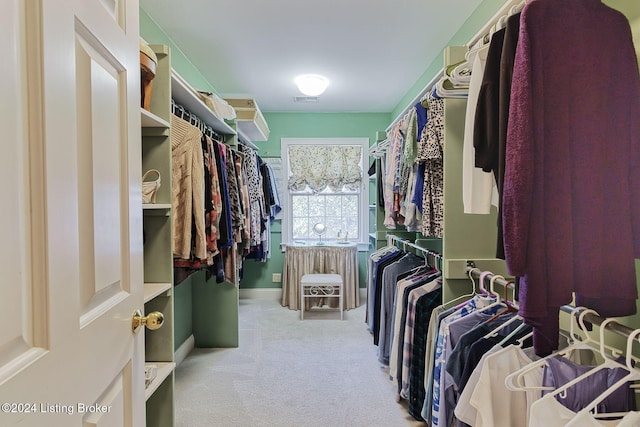 spacious closet featuring light carpet