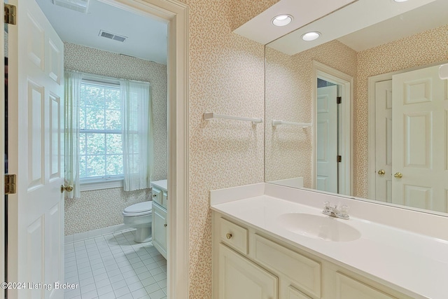 bathroom featuring toilet, vanity, and tile patterned flooring