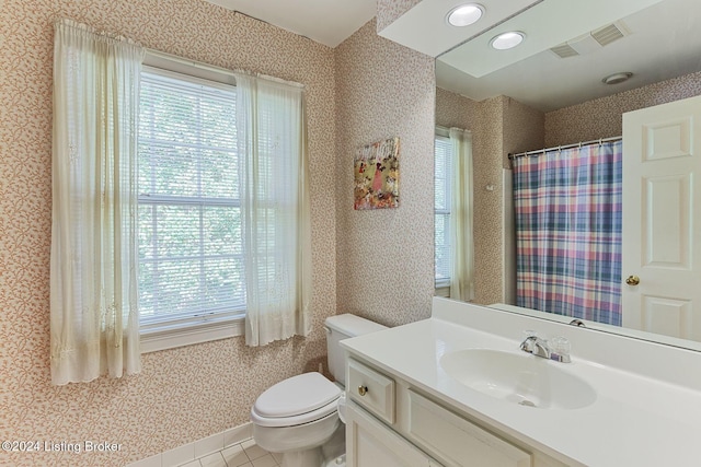 bathroom with vanity, tile patterned floors, and toilet