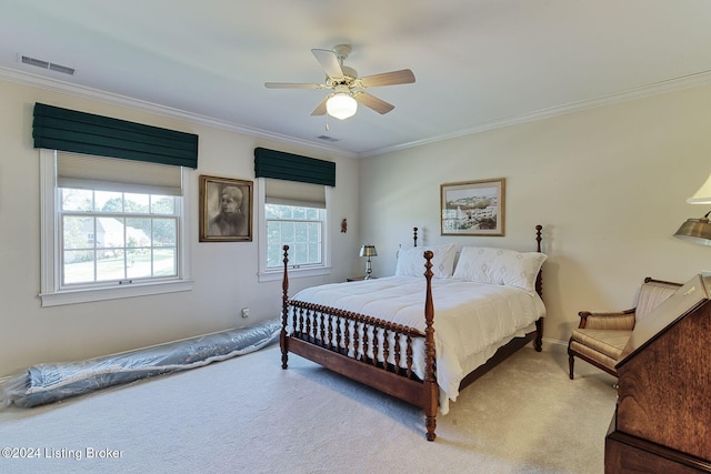 carpeted bedroom featuring ceiling fan and crown molding