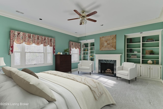 bedroom with ornamental molding, light carpet, ceiling fan, and a high end fireplace