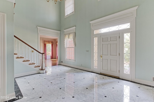 foyer entrance with a high ceiling