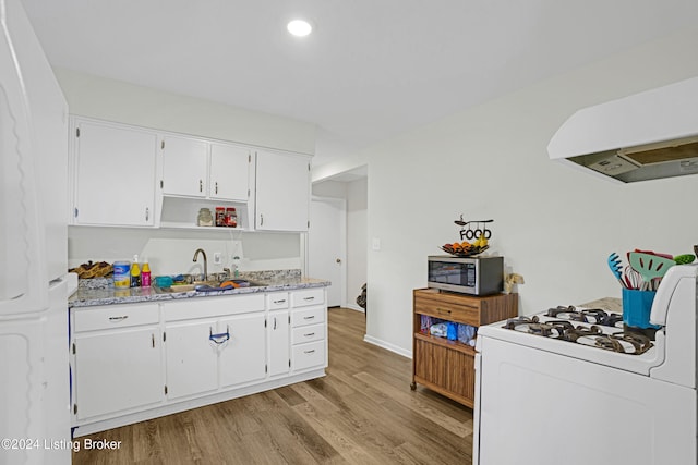 kitchen featuring light hardwood / wood-style floors, sink, light stone countertops, white cabinetry, and white range with gas stovetop