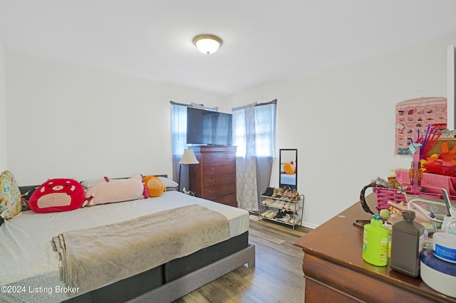 bedroom with dark hardwood / wood-style flooring