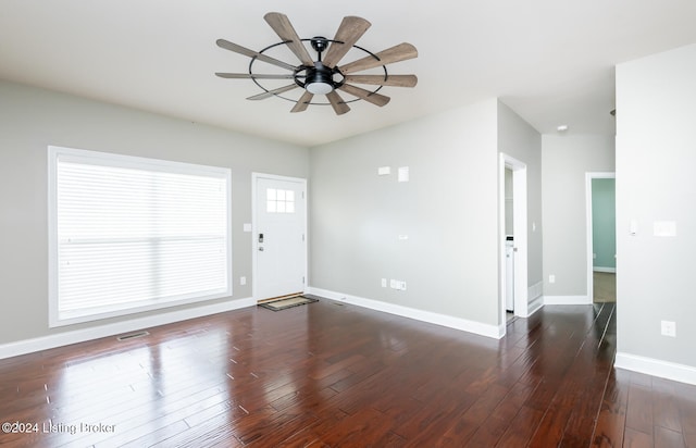 interior space featuring dark wood-type flooring and ceiling fan