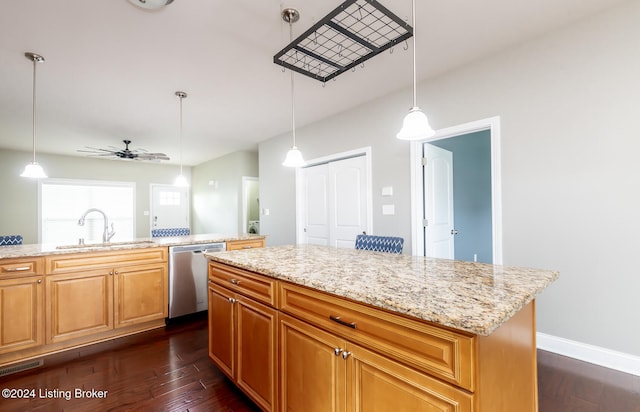 kitchen featuring a kitchen island, dark hardwood / wood-style floors, pendant lighting, sink, and dishwasher