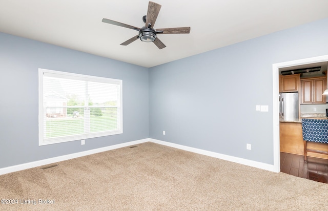 empty room with hardwood / wood-style flooring and ceiling fan