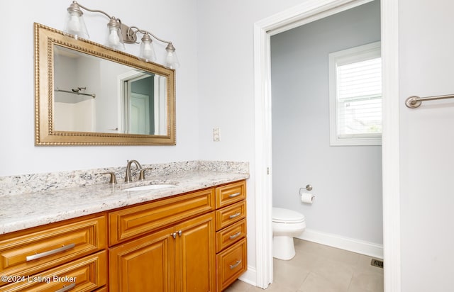 bathroom featuring tile patterned floors, vanity, and toilet