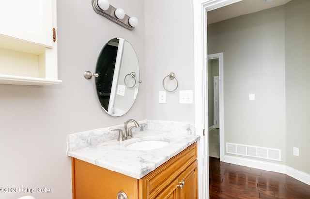 bathroom with hardwood / wood-style floors and vanity