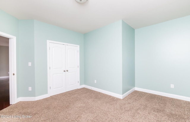 unfurnished bedroom featuring carpet flooring and a closet